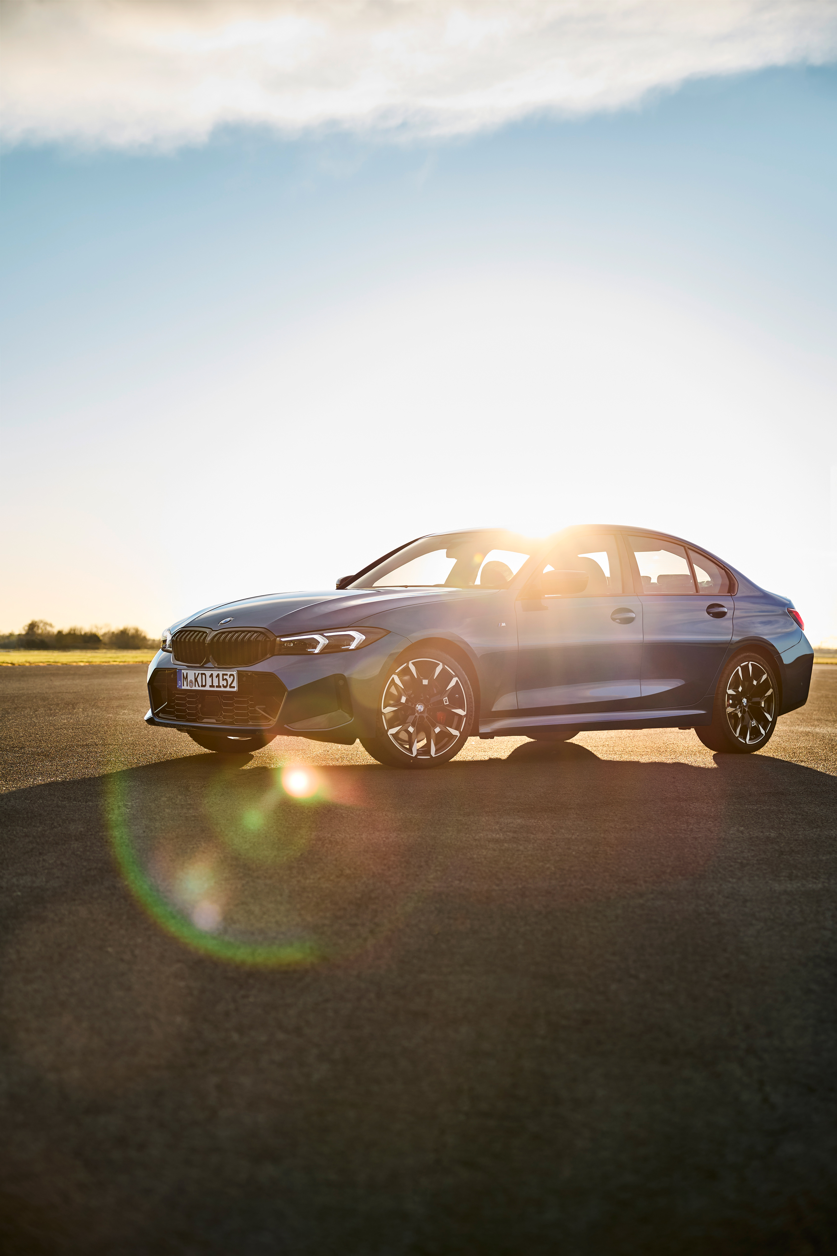 Blue BMW 3 Series Saloon photographed in low evening light
