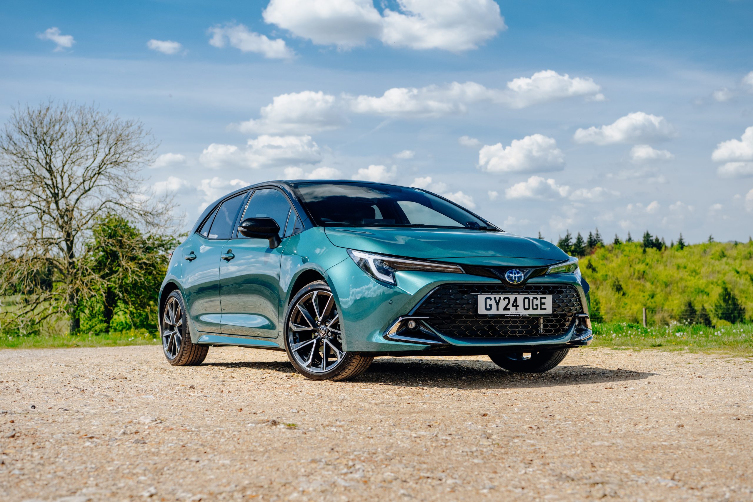 Green Toyota Corolla hatchback on a rural British road