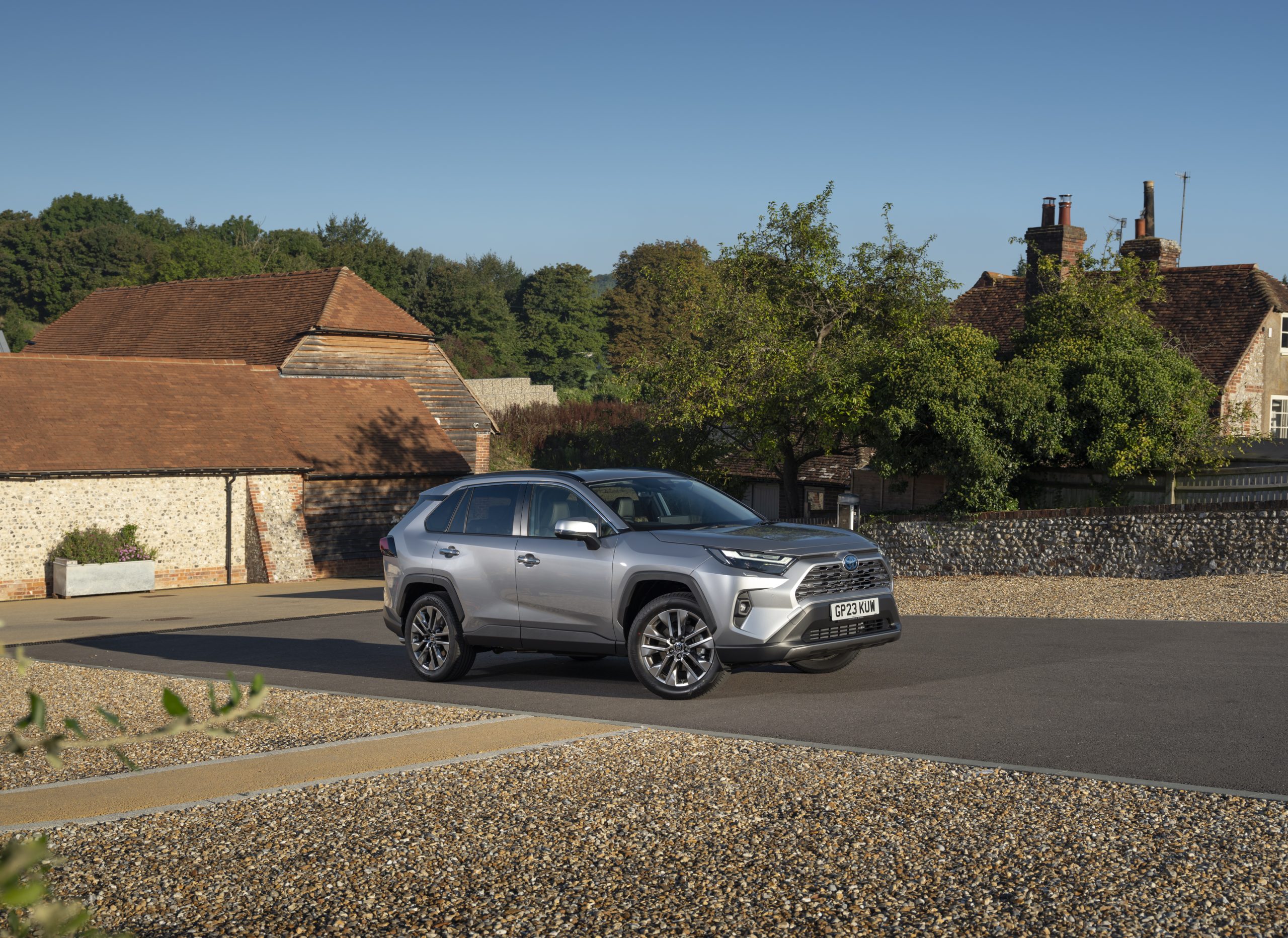 Red Toyota RAV4 Hybrid, a large SUV and 4x4 class example